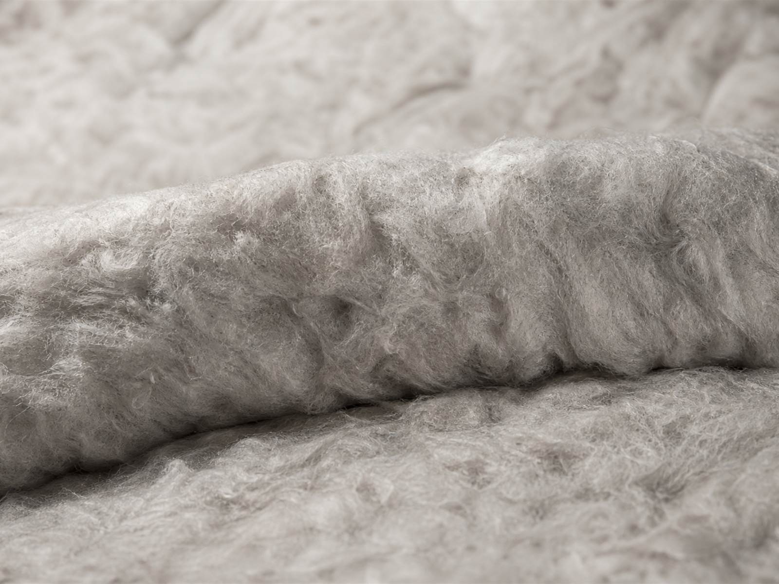 Macro view of cold weather insulation material showing loft structure used in tactical winter jackets