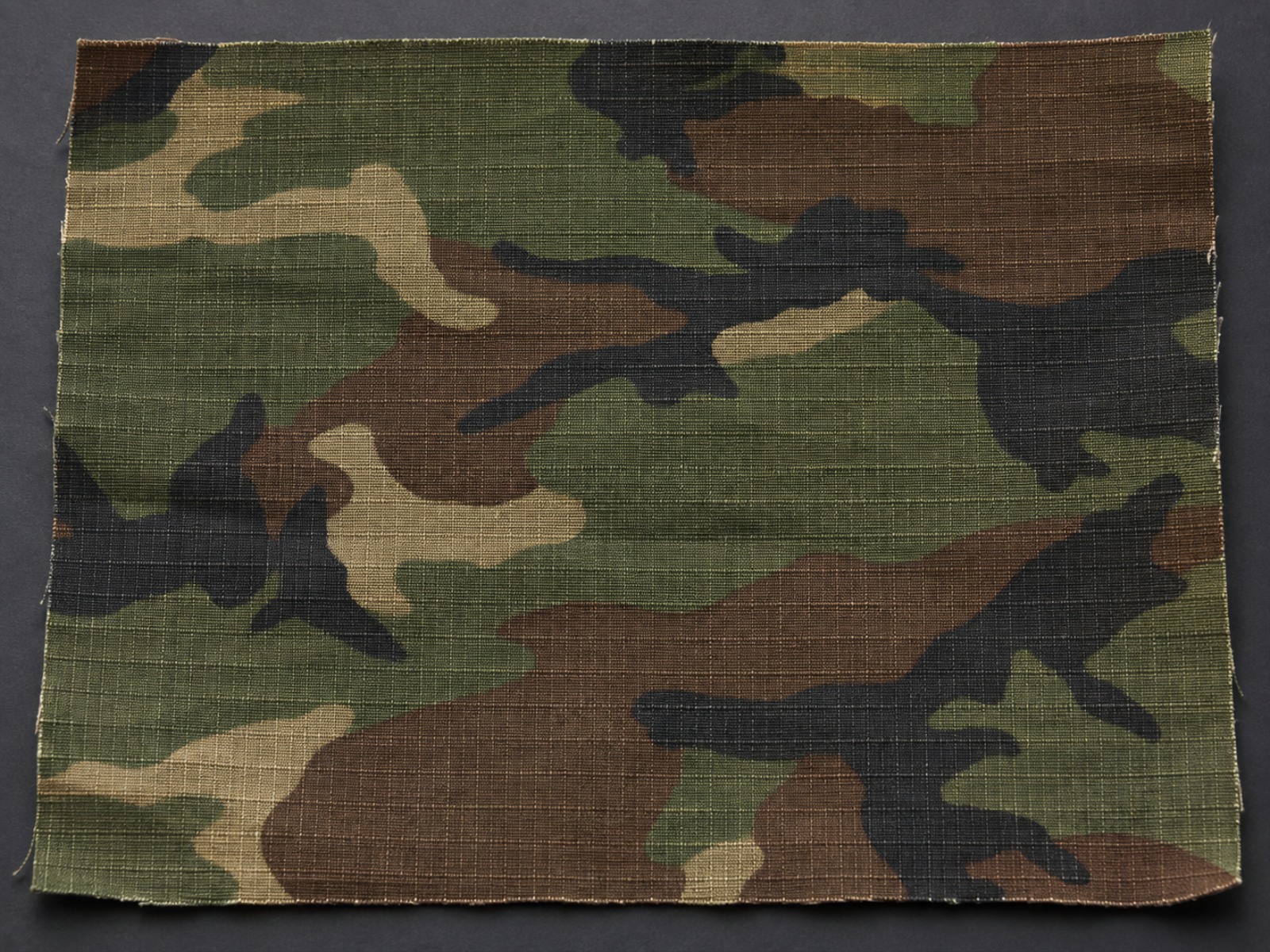 Macro view of NYCO ripstop nylon cotton fabric showing the ripstop grid used in tactical uniforms